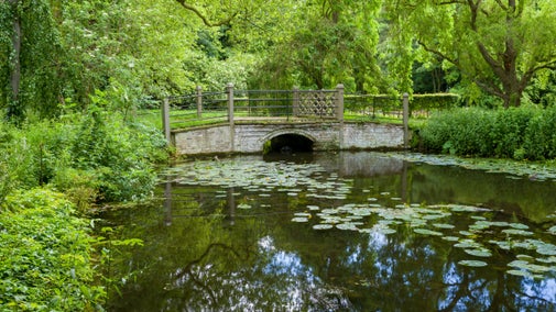 Fairhaven Bridge over Quy Water in the gardens at Anglesey Abbey, Cambridgeshire